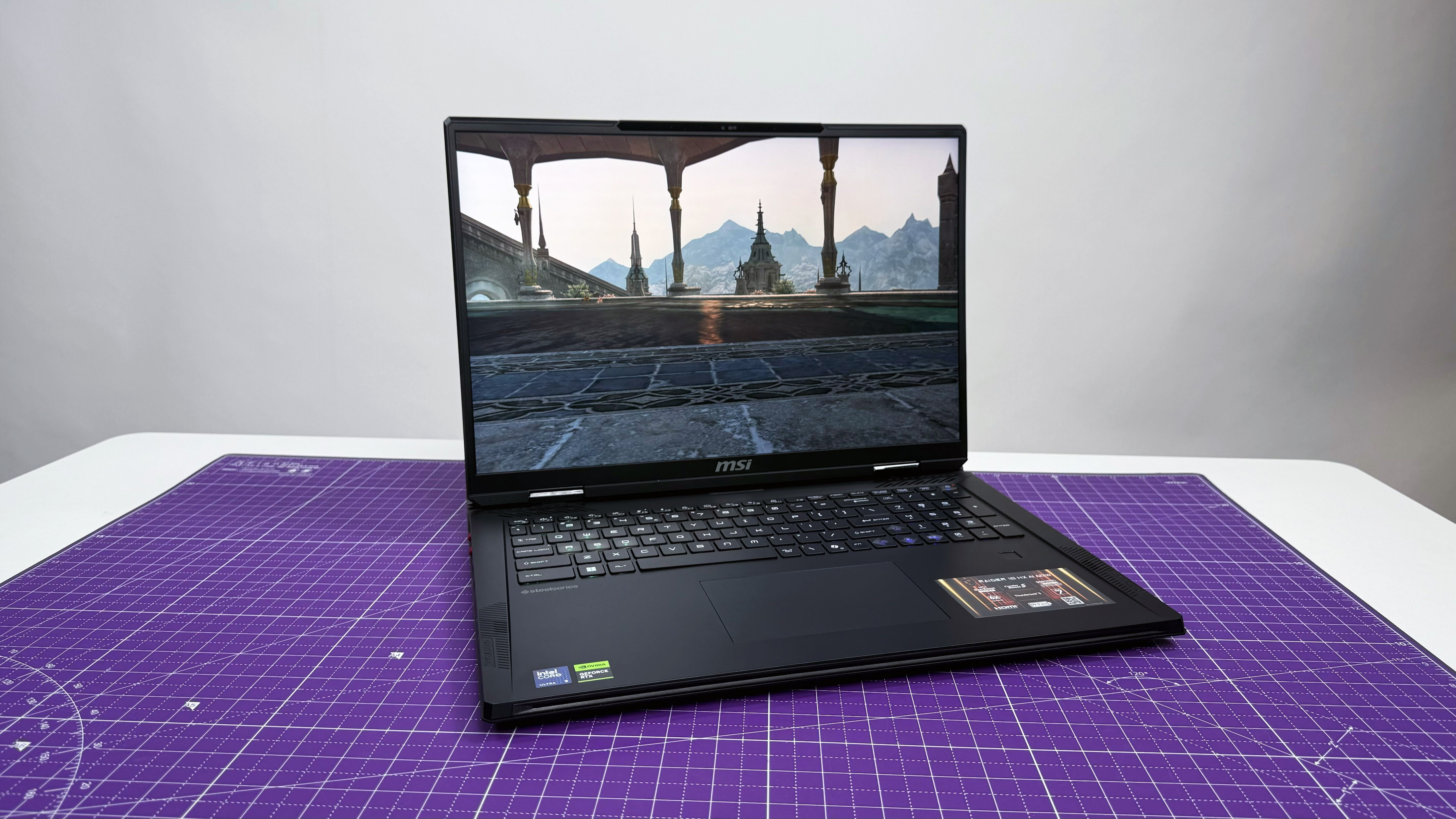MSI Raider 18 HX AI gaming laptop open facing on a purple mat against a gray background.