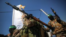Armed wing of Hamas take part in a military parade to mark the 2014 war with Israel, 19 July 2023