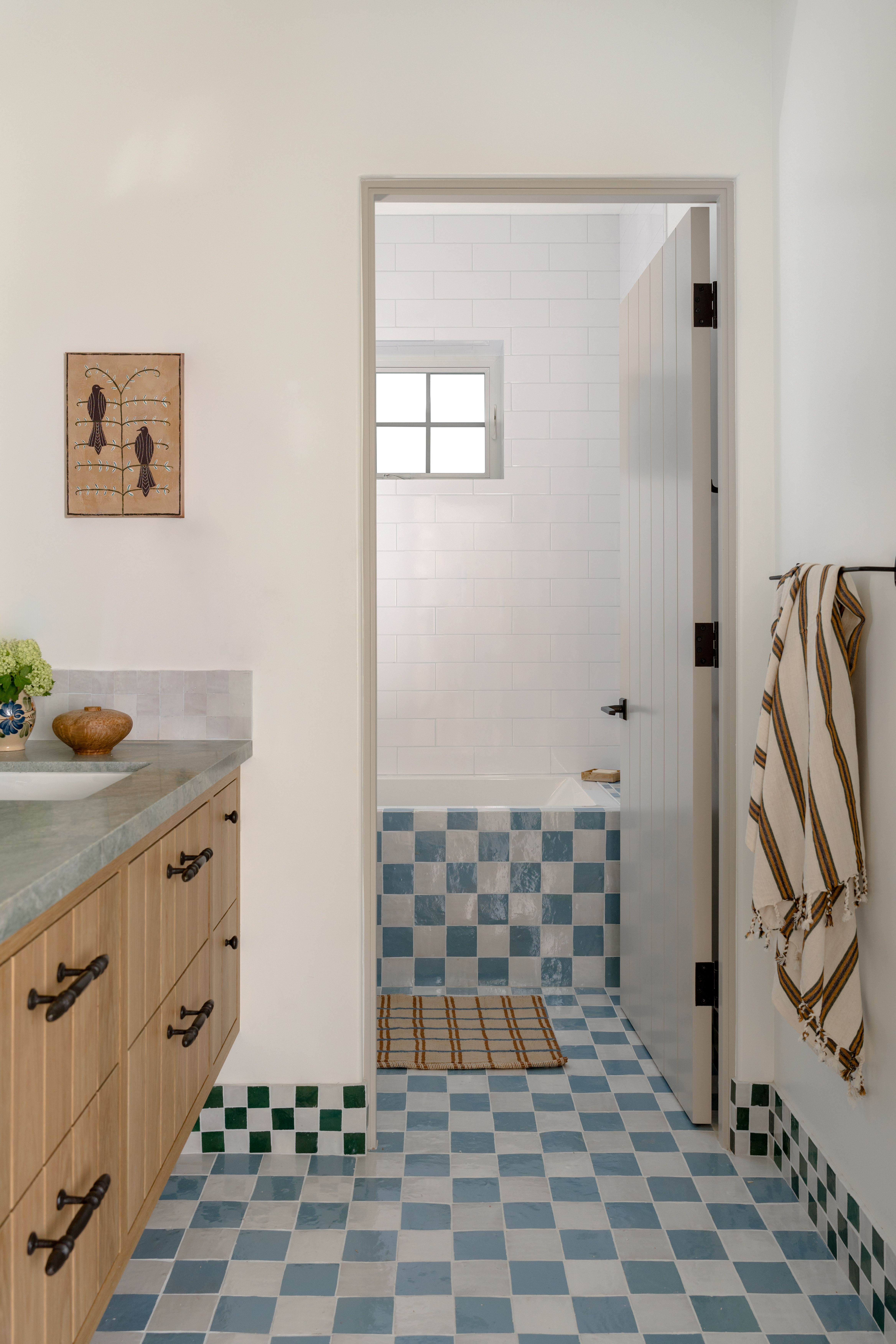Checkerboard floor tiles in bright bathroom