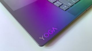 Close up of the "Yoga" logo on the keyboard deck of the Lenovo Yoga Slim 7i Aura edition