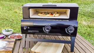 BakerStone Portable Gas Series Pizza Oven Box outside on table