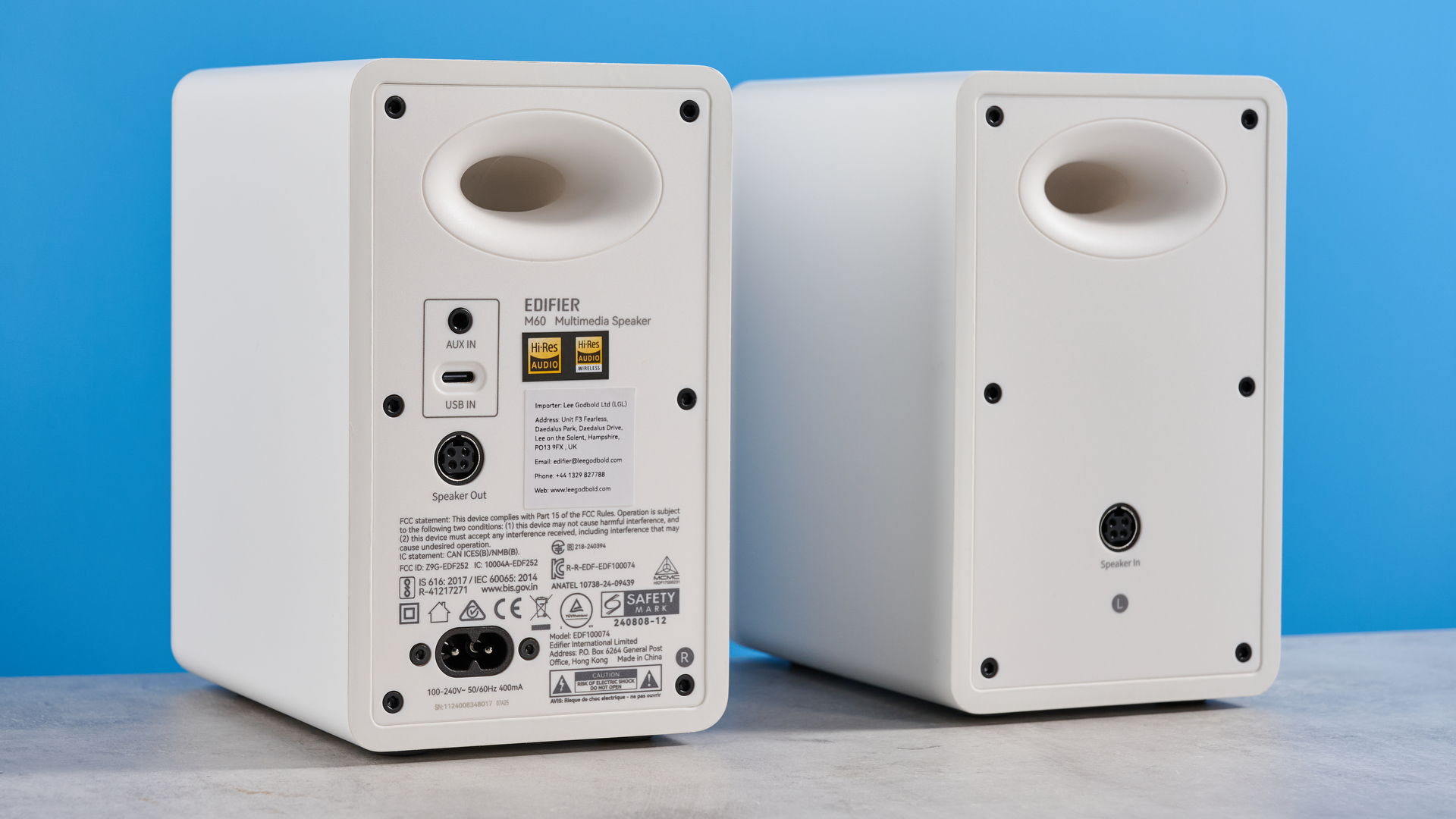 the edifier m60 bookshelf speakers in white photographed against the blue tom's guide background