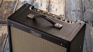 Close up of the handle, Fender logo and top panel of the Fender Blues Junior IV amp with cream chickenhead knobs