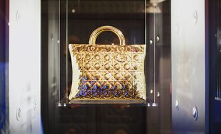 The Lady Dior bag in gold-painted porcelain