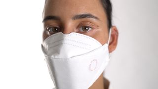 woman wearing a surgical mask with one of Buly 1803's perfumed mask stickers