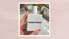 Image of hand holding Jones Road Fragrance in 'Shower', on a pink background