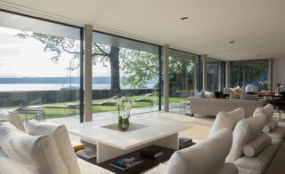 living room with large glass windows with a view of water