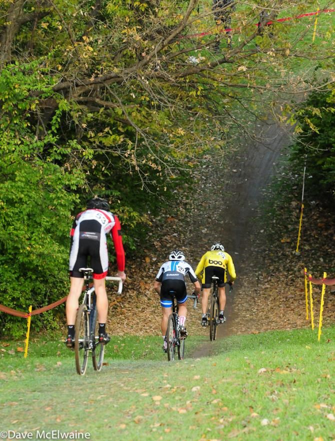 Riders make the steep descent into the wooded section of the course