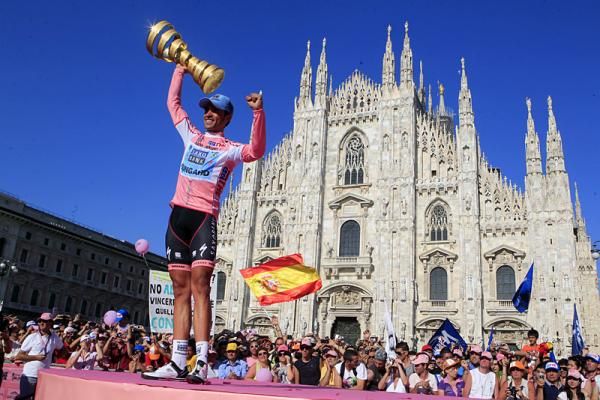 2011 Giro d'Italia champion Alberto Contador hoists aloft the winner's trophy in Milan.
