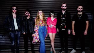 Morganway: the six-piece band pose in front of a metal door