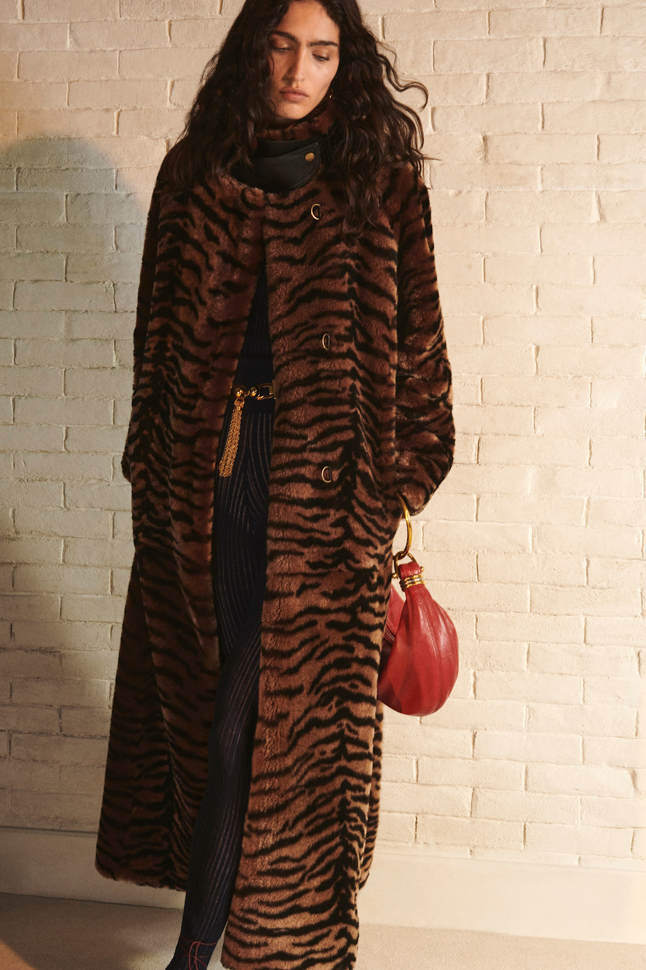 A model weraing a dark orange and black tiger print fur coat at Chlo&eacute; Resort 2025