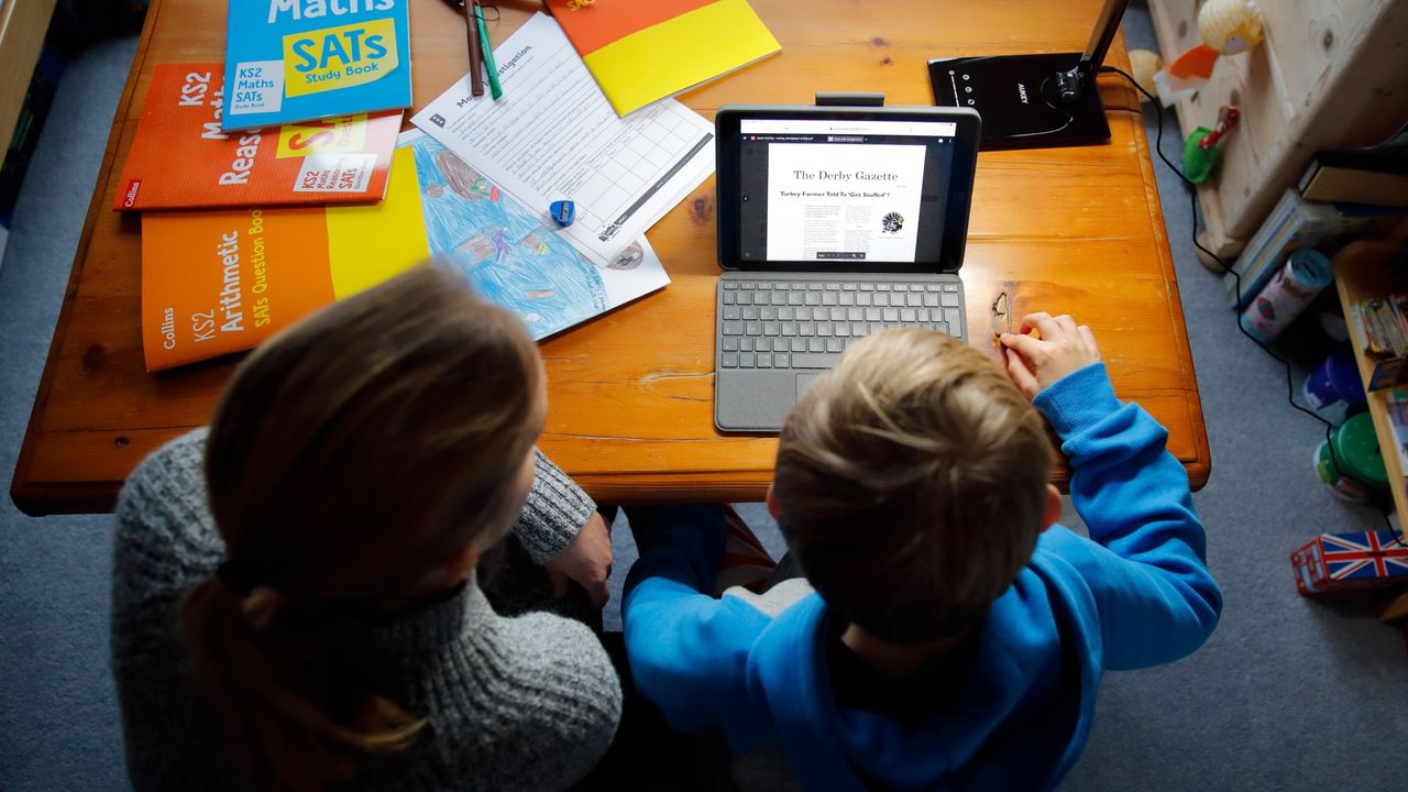 A woman schools her child at home during Covid, January 2021