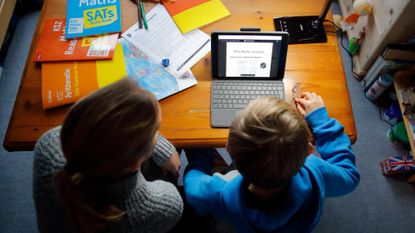 A woman schools her child at home during Covid, January 2021