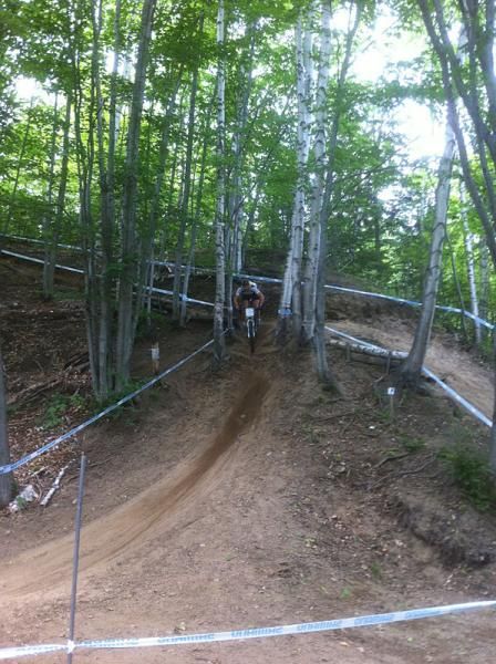 A rider on a steep drop on the cross country course