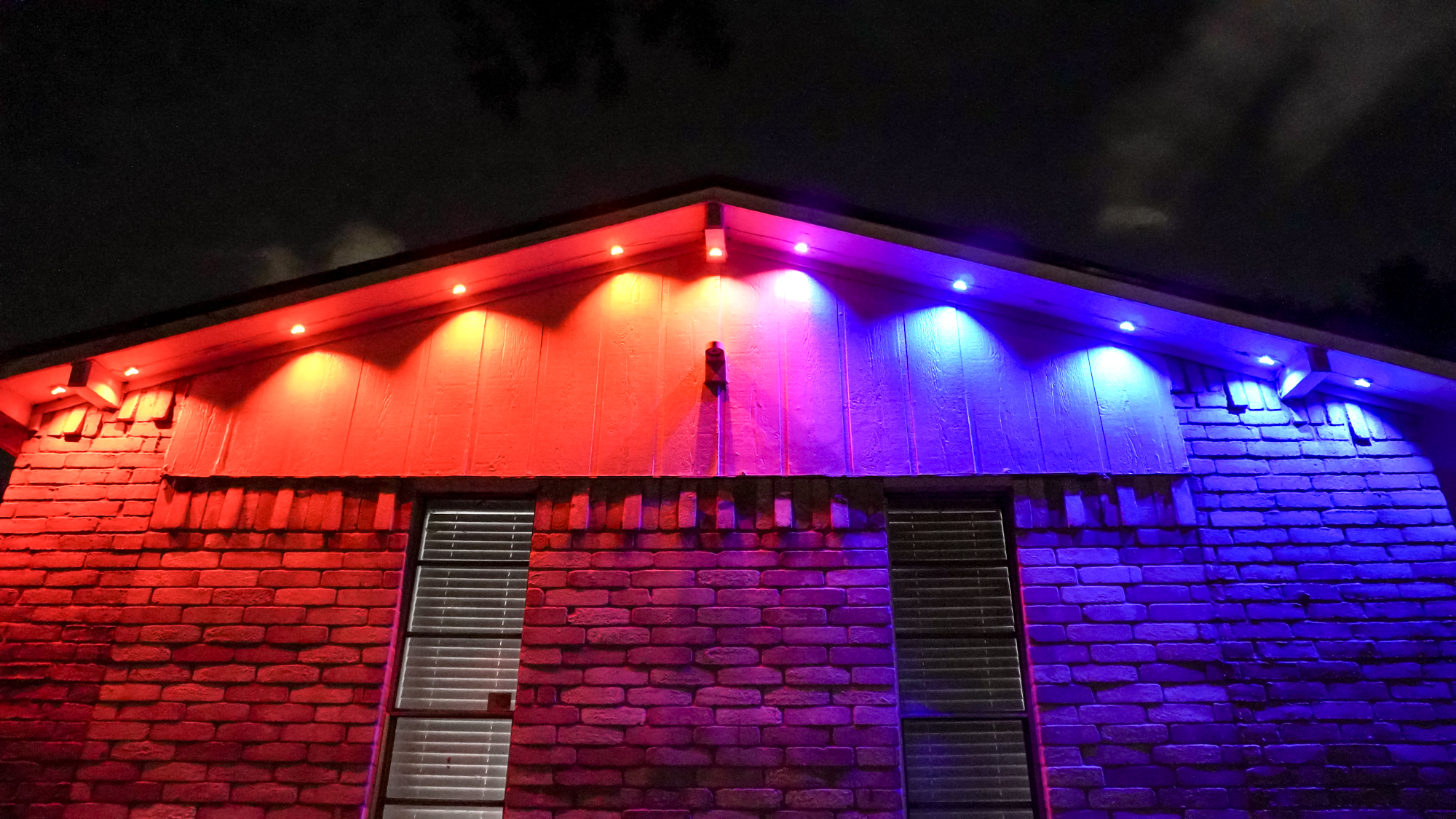 An underhead view showing a roof&#039;s ridge lit with Govee&#039;s Prism permanent outdoor lights