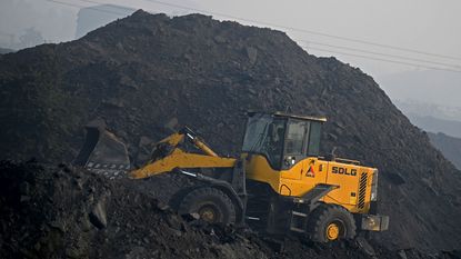 Bulldozer on a heap of coal