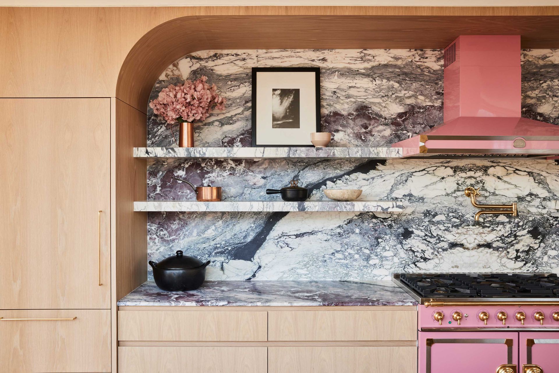 a kitchen with a bold marble backsplash