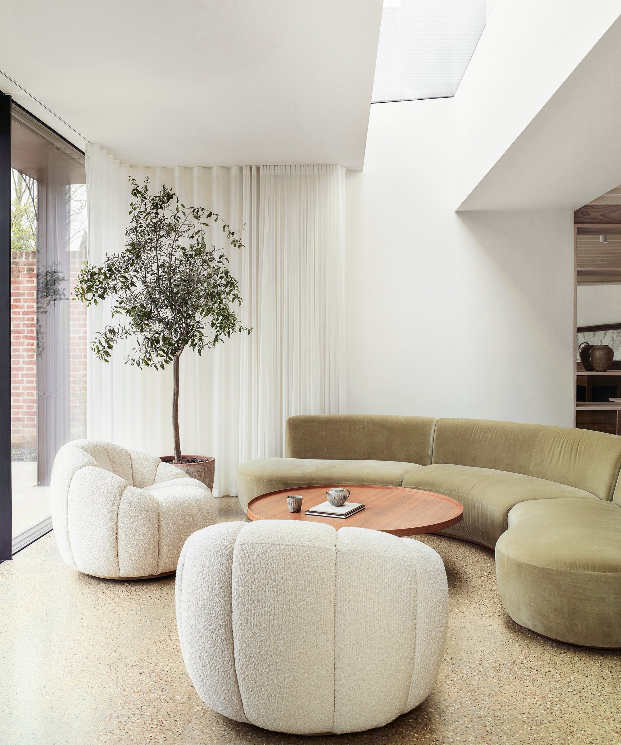 neutral living room with curved beige sofa