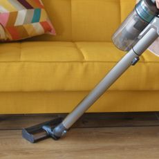 Cordless vacuum cleaner vacuuming floor