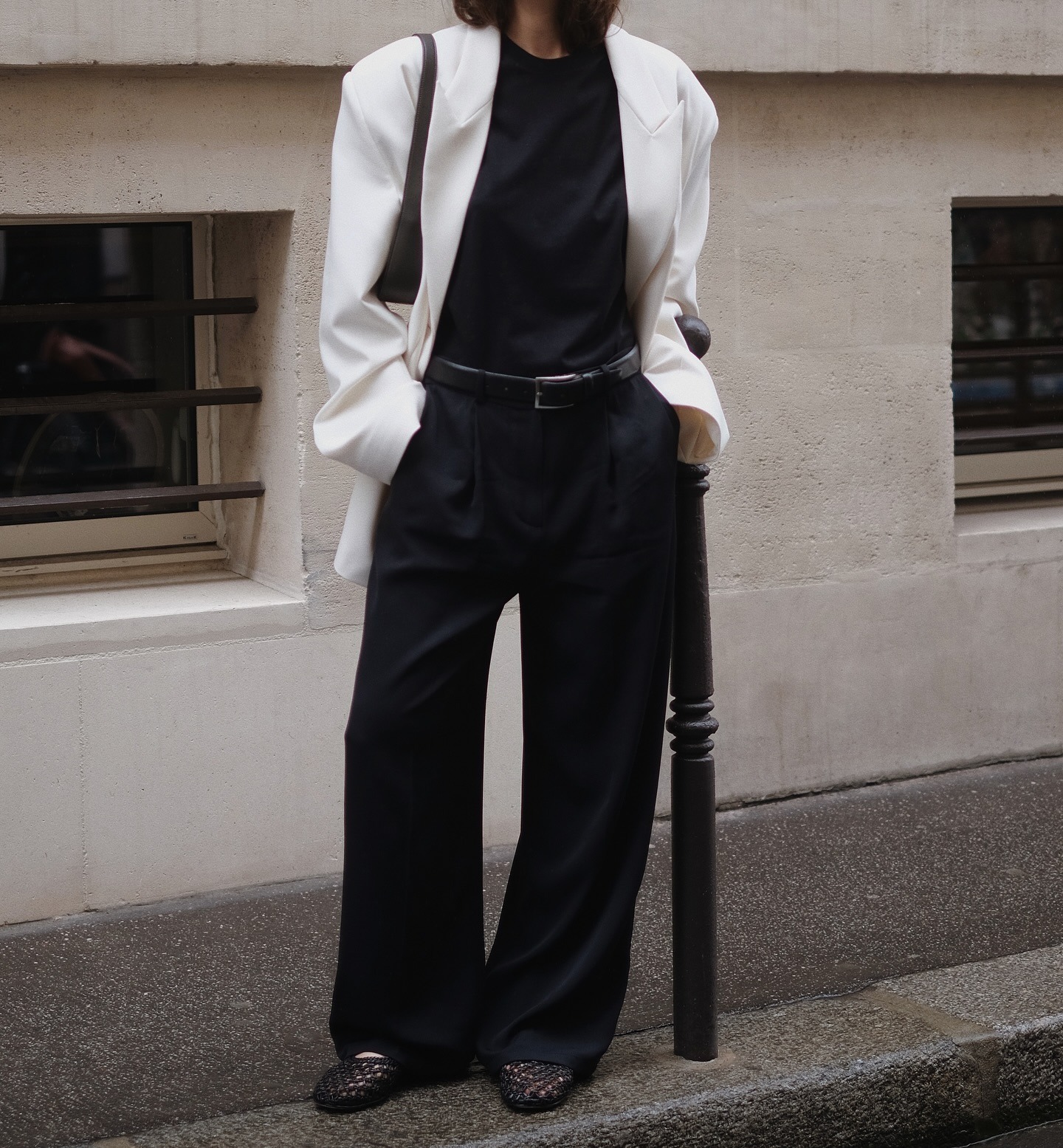 Influencer wearing chic, minimalist black and white outfit.