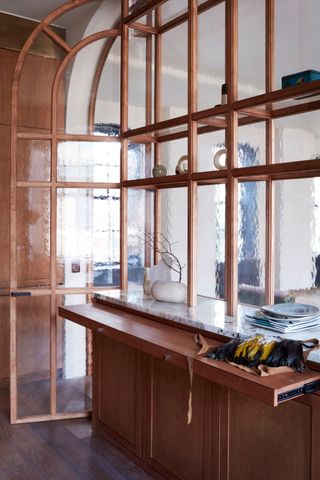a small kitchen with a glass partition screen