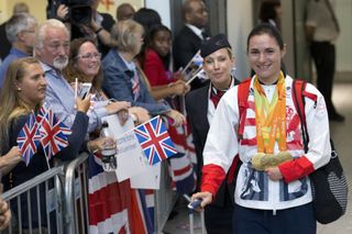 British paralympic gold medalist Sarah Storey (R) is greeted by wellwishers after returning from the Rio 2016 Paralympic Games in Brazil, at Heathrow airport in London on September 20, 2016. - Rio said farewell to the 2016 Paralympics Sunday in a closing ceremony showcasing Brazil's passion for music and celebrating what many consider to have been a surprisingly successful Games. Eleven days of competition where China dominated the medals table, followed by Britain, ended earlier with the last few events, including marathons and wheelchair rugby. (Photo by JUSTIN TALLIS / AFP) / CORRECTING DATE The erroneous mention[s] appearing in the metadata of this photo by JUSTIN TALLIS has been modified in AFP systems in the following manner: [September 20, 2016] instead of September 19, 2016]. Please immediately remove the erroneous mention[s] from all your online services and delete it (them) from your servers. If you have been authorized by AFP to distribute it (them) to third parties, please ensure that the same actions are carried out by them. Failure to promptly comply with these instructions will entail liability on your part for any continued or post notification usage. Therefore we thank you very much for all your attention and prompt action. We are sorry for the inconvenience this notification may cause and remain at your disposal for any further information you may require. (Photo by JUSTIN TALLIS/AFP via Getty Images)