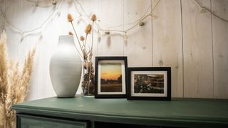 Printique photo prints in frames on a sideboard