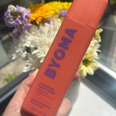 a hand holding a bottle of byoma hydrating milky toner
