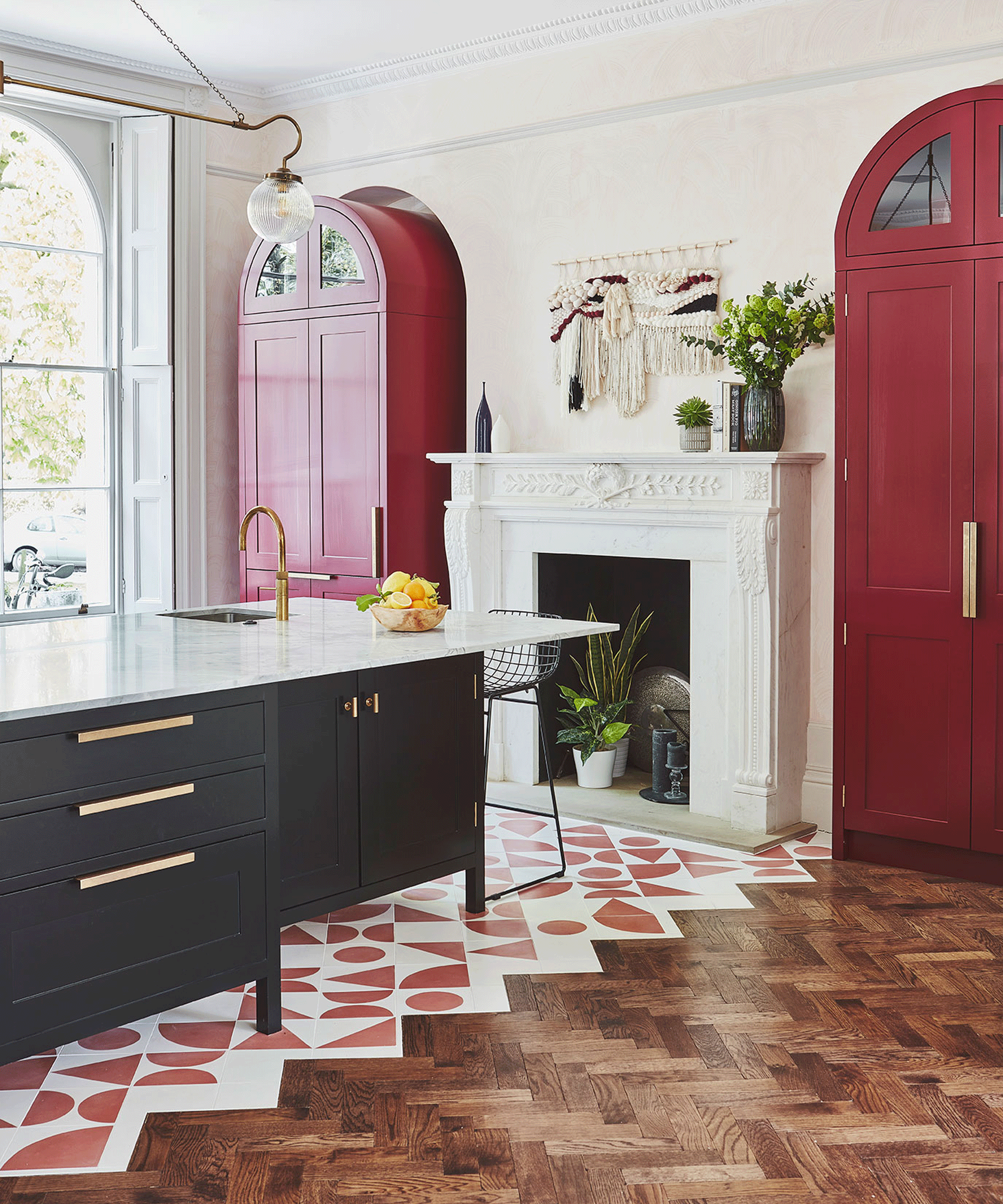 Open plan kitchen with red and white tiled zig zag floors