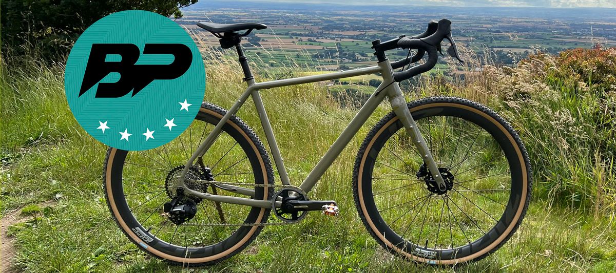 A gravel bike at the top of a ridge with a view