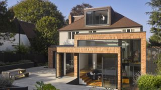 large extension to detached house with roof extension