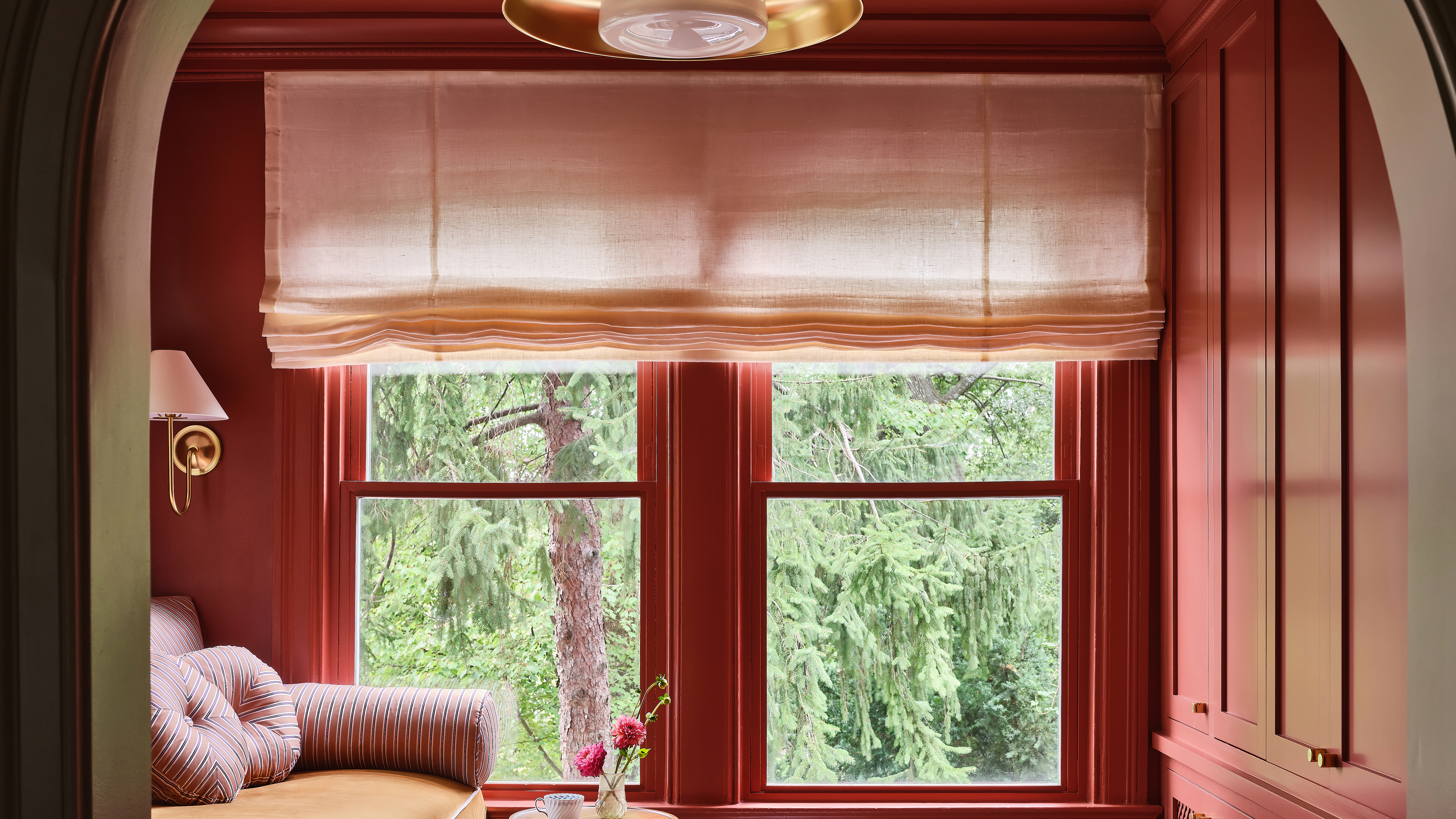 pink dressing room with large roman blind at a window