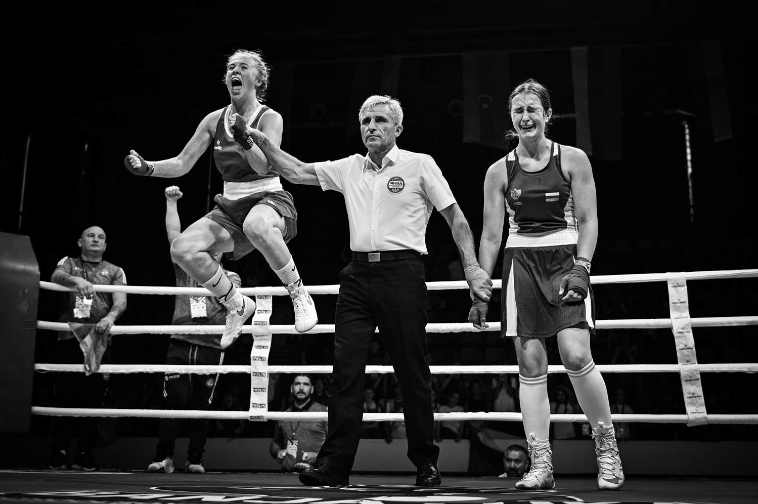 Photograph titled 'Victory and Defeat', taken by Vladimir Tadic from Bosnia and Herzegovina and the winner of the Sports category of the 14th season of the HIPA (Hamdan bin Mohammed bin Rashid Al Maktoum International Photography Award) photography competition. Image description: In a boxing ring, a referee grips the wrists of two teenage girls, one of them about to be declared the winner. As the referee raises the victor's arm, she bursts into a moment of pure euphoria, her face lit with joy and triumph, realising that months of training, sacrifice and termination have led to this achievement. Beside her, the defeated opponent is overwhelmed by disappointment. Her body language speaks volumes, a mix of exhaustion, heartbreak and the sting of coming so close. Yet, in that contrast between joy and sorrow, lies the essence of competitive sport.
