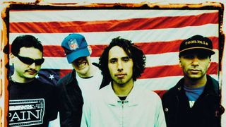 Rage Against The Machine standing in front of a US flag