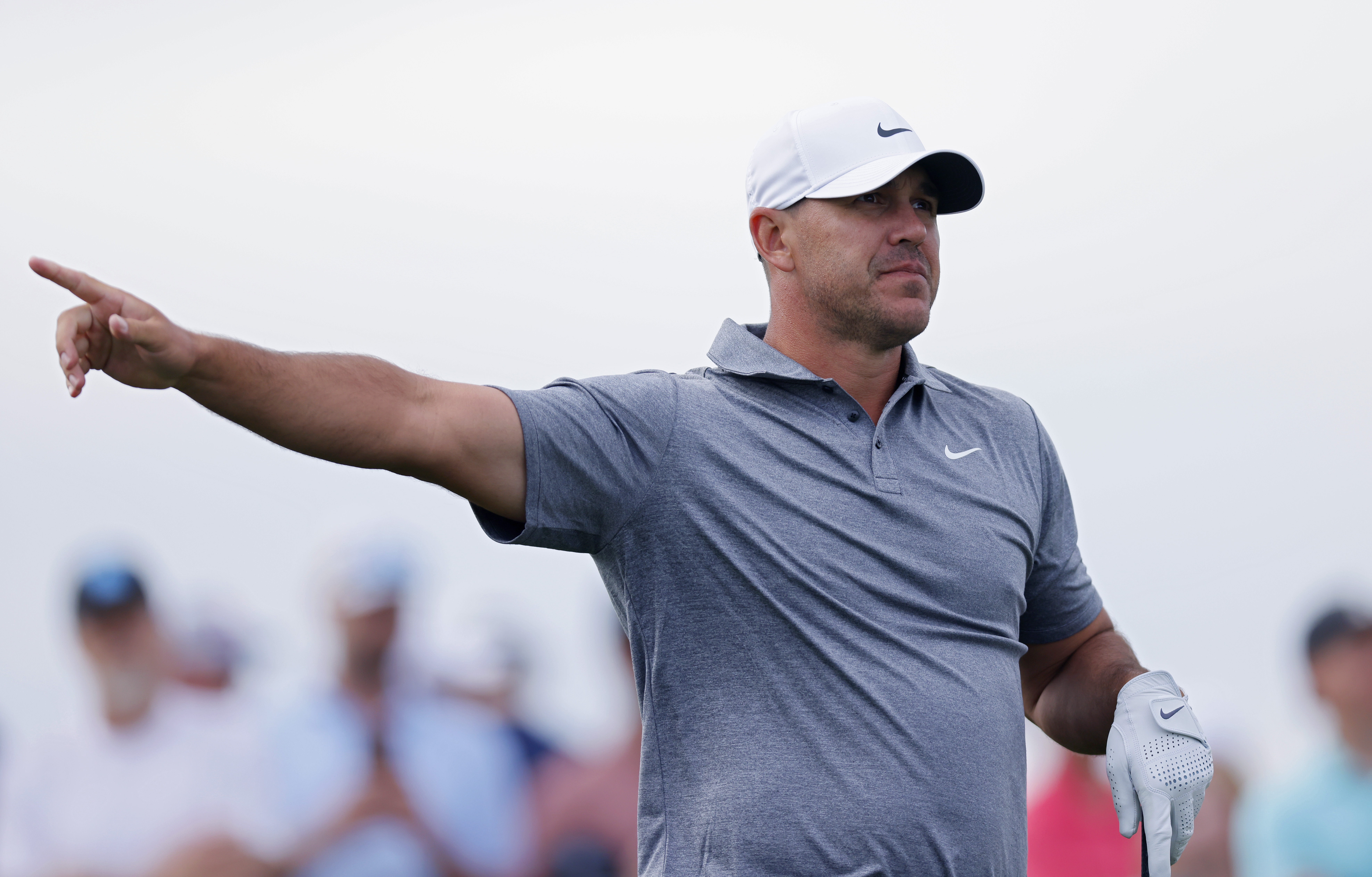 Brooks Koepka points right