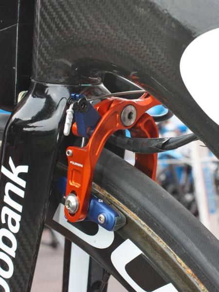Unless something has changed with the bike's overall configuration and cable routing, the unique scissor-type front brake is likely to be included in the package as virtually nothing else on the market will work. Don&rsquo;t count on the trick orange and blue anodizing, though.