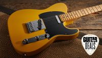 A Fender Player II Modified Telecaster electric guitar lying on a rug with the Guitar World deals logo in the corner