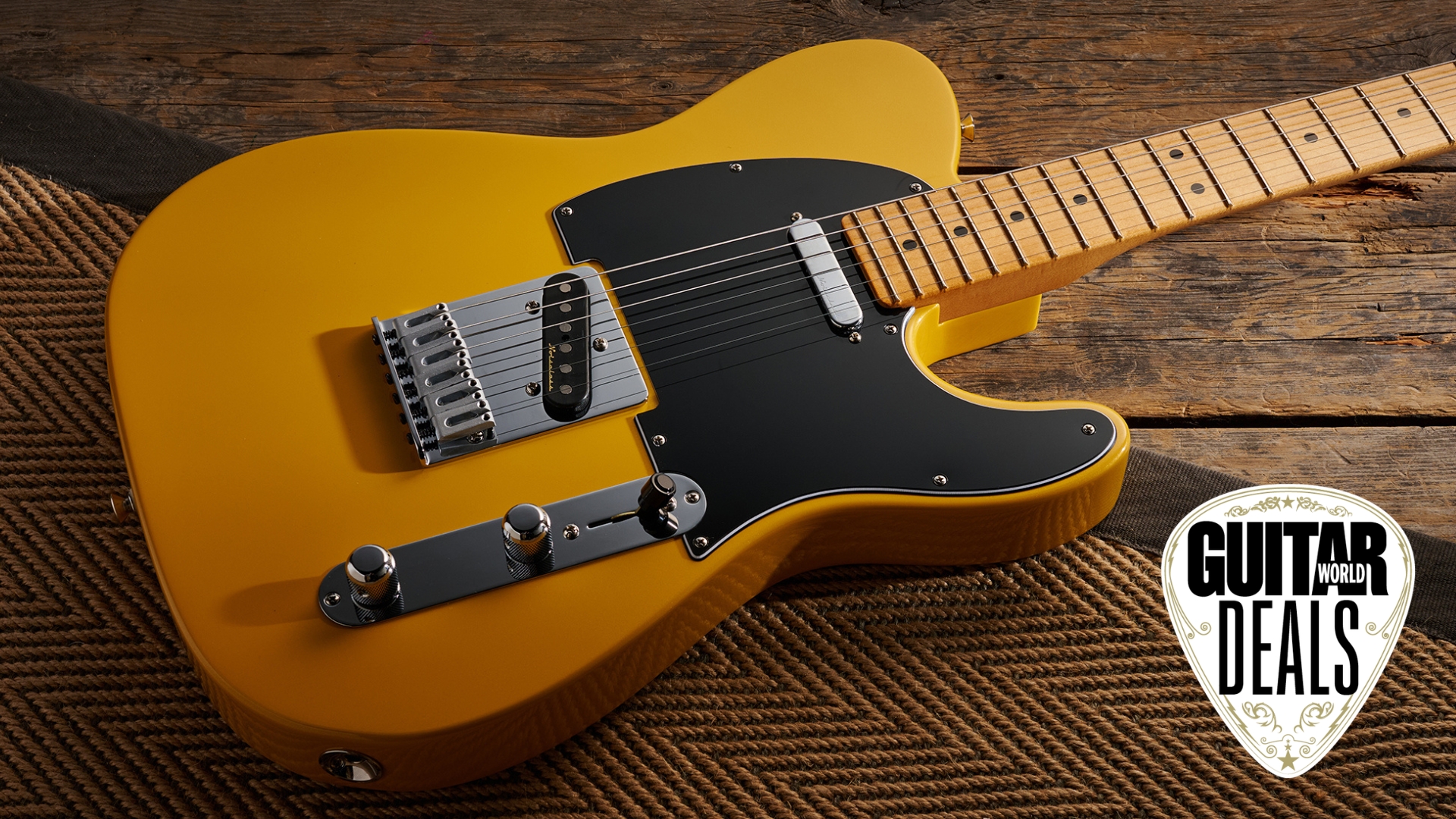 A Fender Player II Modified Telecaster electric guitar lying on a rug with the Guitar World deals logo in the corner