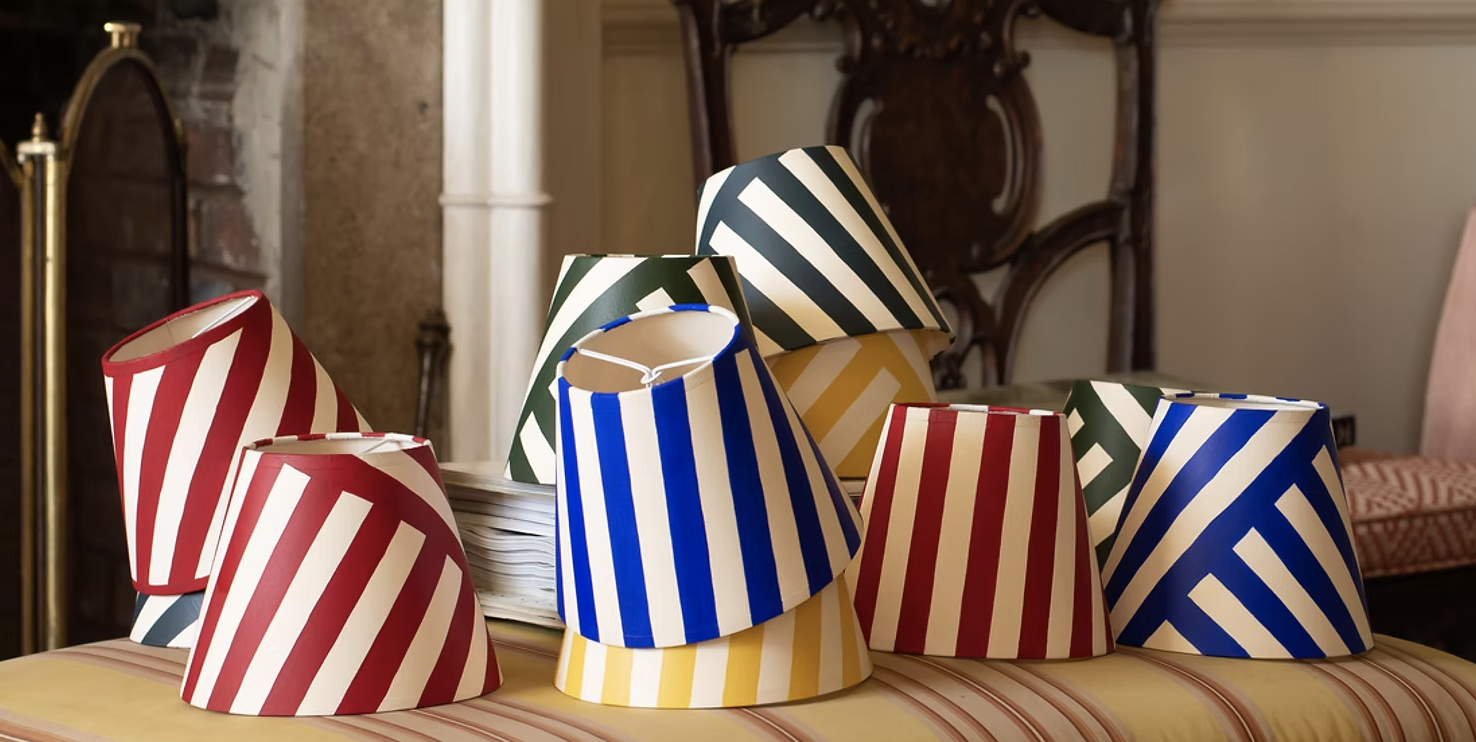 lampshades in bright primary modern stripes stacked up in piles