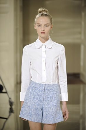 Model in simple white shirt & skirt