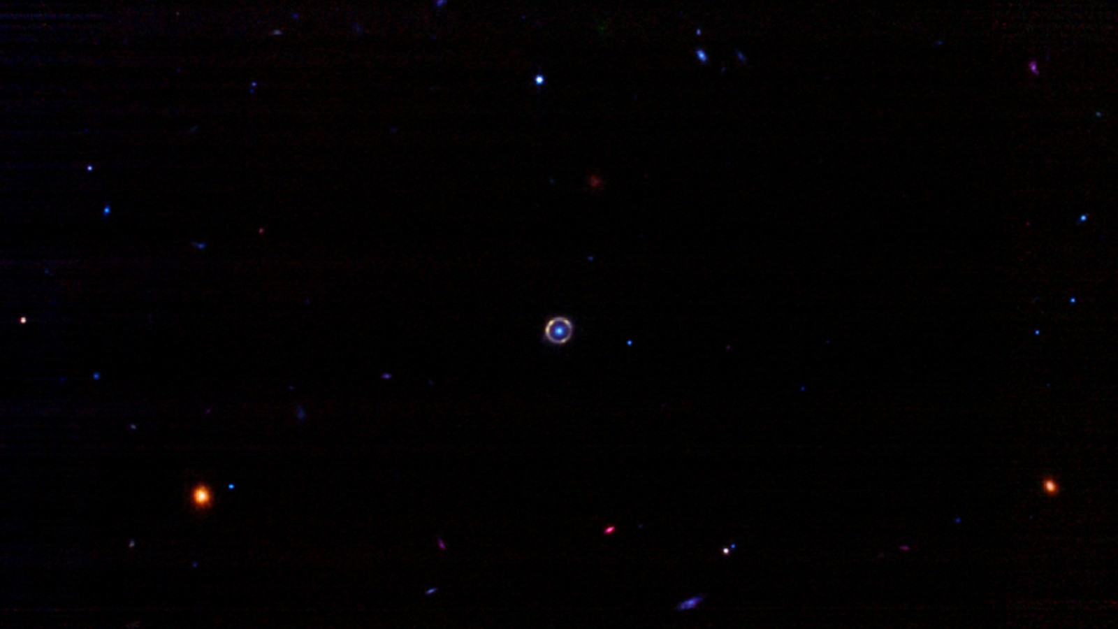 a tiny bright ring against dark space backgrou