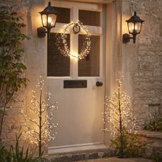 The White Company Christmas wreath and lights on front door.