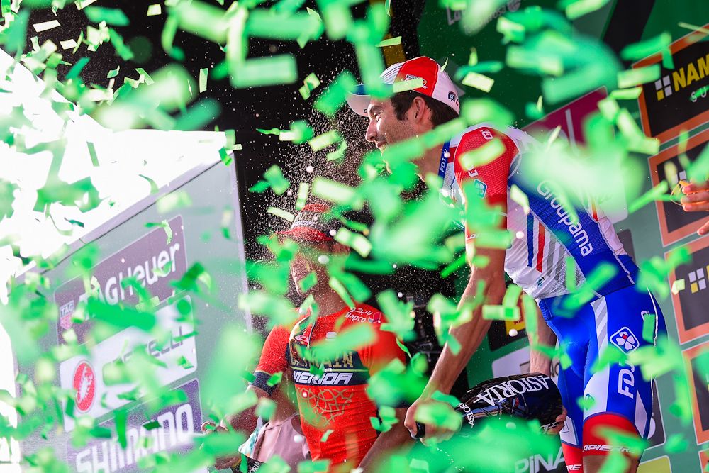Confetti floats past Thibaut Pinot on the Il Lombardia podium