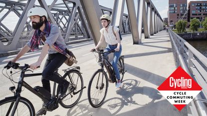 A male and female cyclist riding on bikes to work.