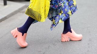woman wearing chunky pink clogs