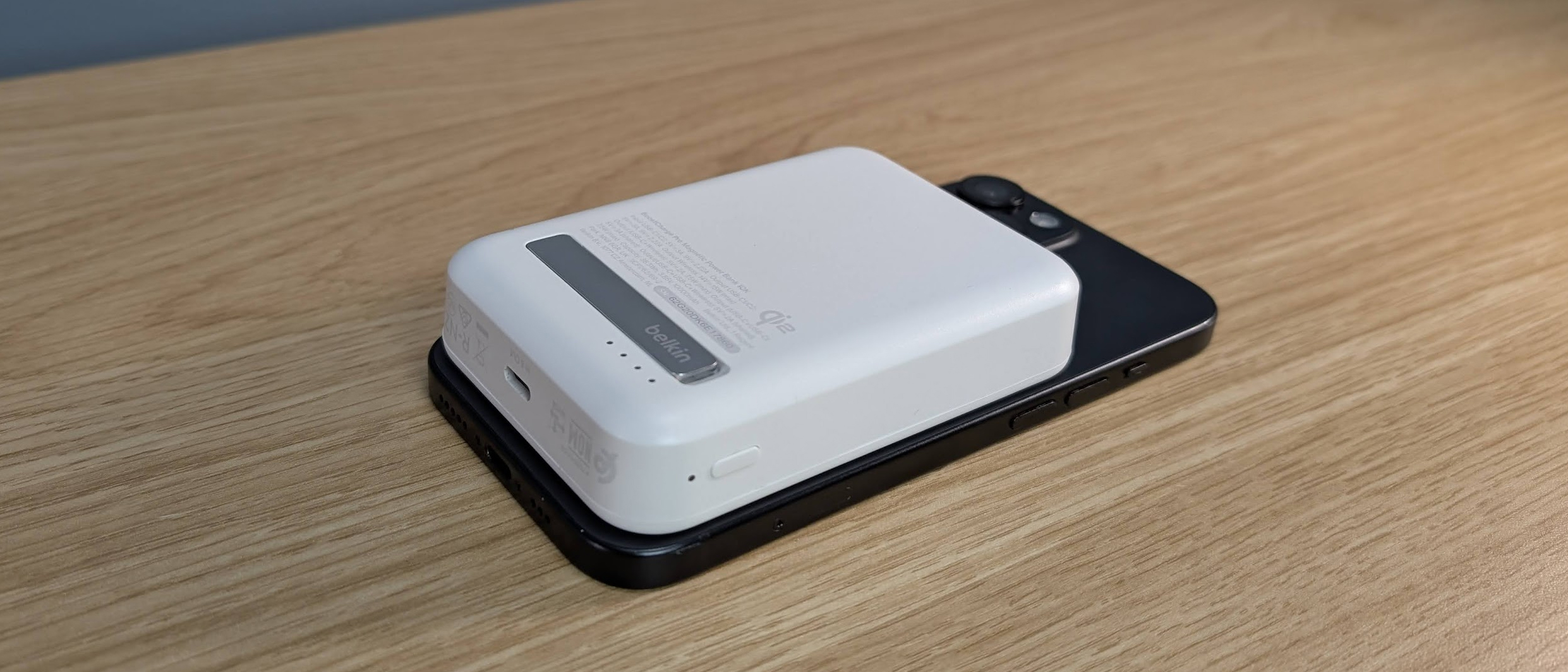 Belkin Boostcharge Pro 15W qi2 power bank sitting on an iPhone 15