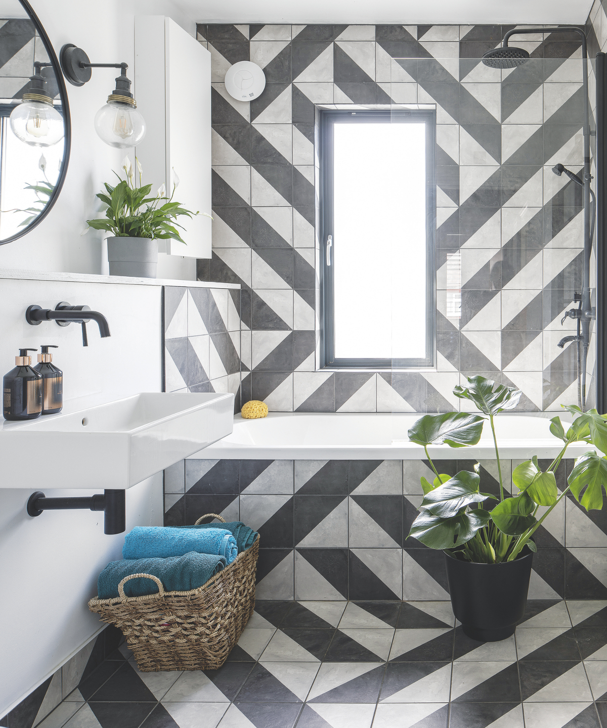 black and white tiles on a bathroom back wall and floor