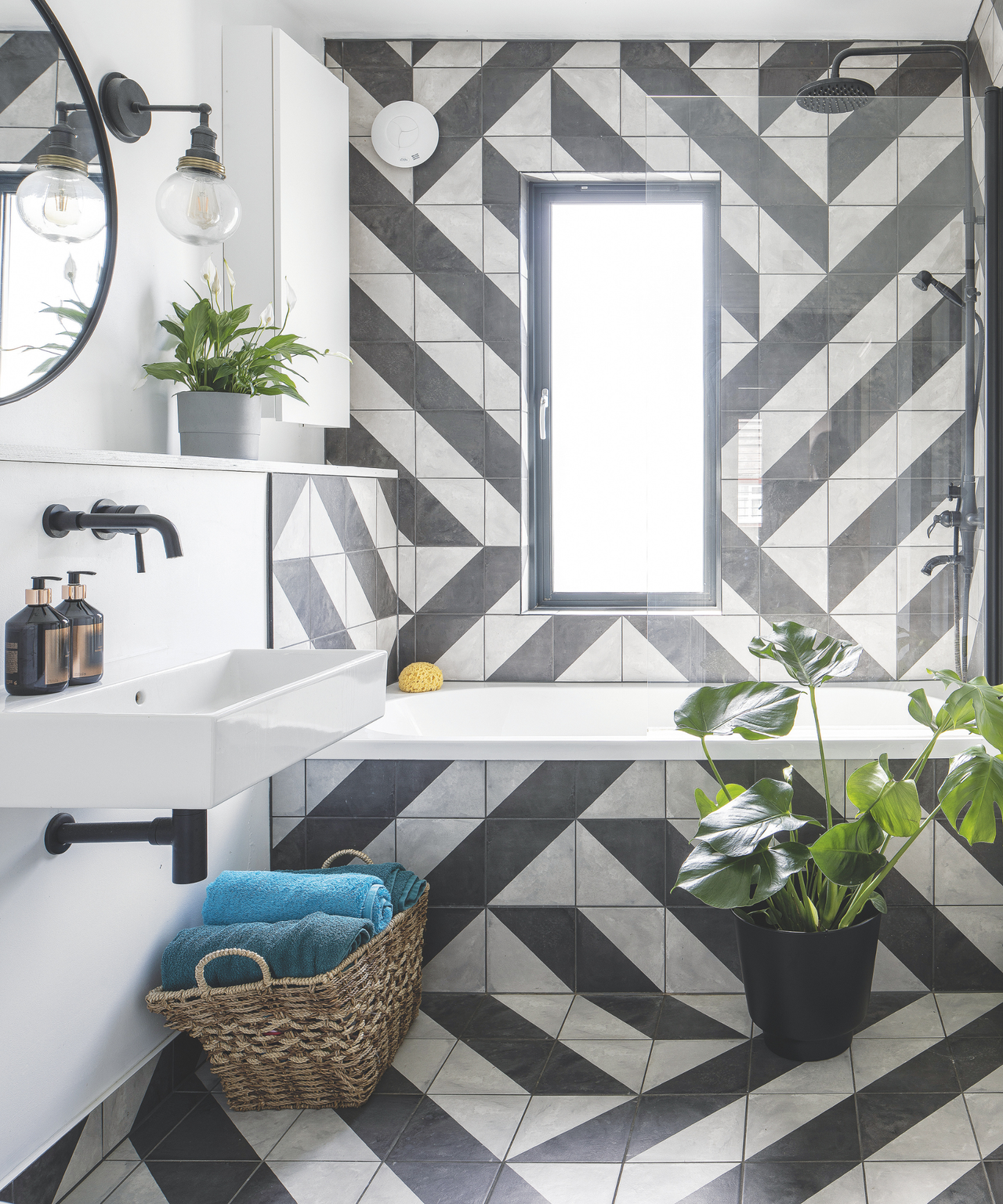 black and white tiles on a bathroom back wall and floor