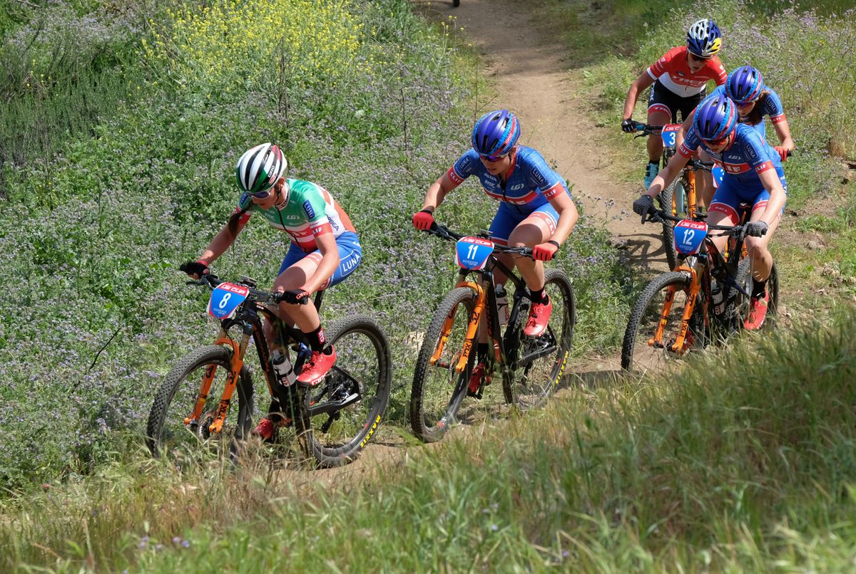 Eva Lechner leading several of her Clif team-mates up a long climb with Emily Batty at the back