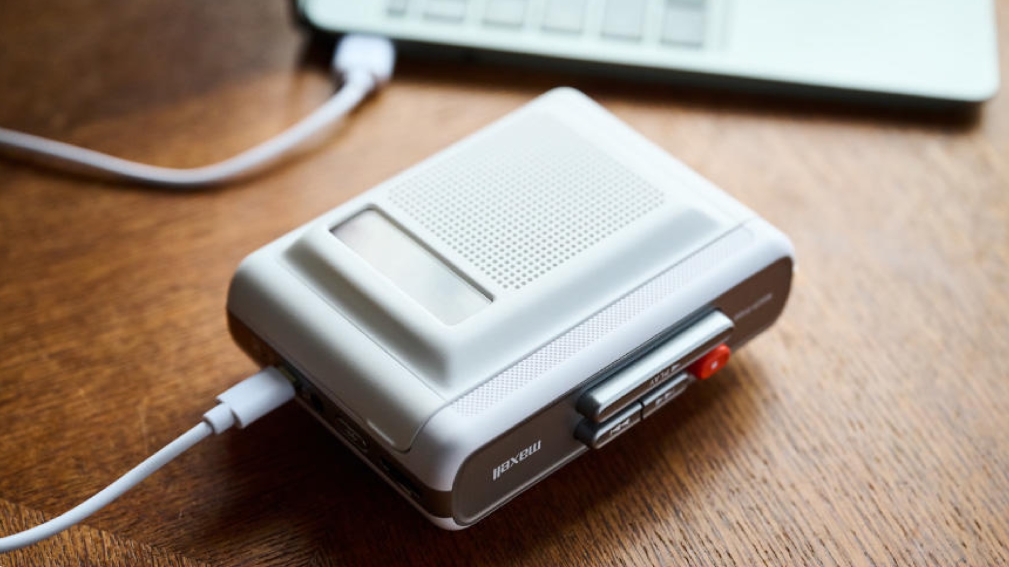 Maxell MXCP-P100S cassette player on a wooden surface. It's a Walkman-esque player with a built-in speaker